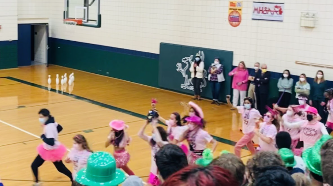 “In a pink flood of tutus, capes and beaded necklaces, seniors usher in the start of another Spirit Week.”