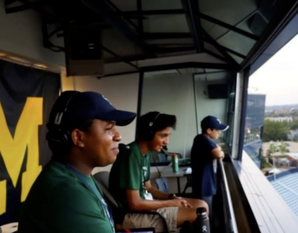 THE SQUARE ROOT OF MAGIC Austin Andrews ‘23 and Nicholas Alumkal ‘23 commentating a football game in the press box at Michigan Stadium, “We offered an entertaining solution to people who couldn’t make it to the games, especially during the pandemic,” said Alumkal. 