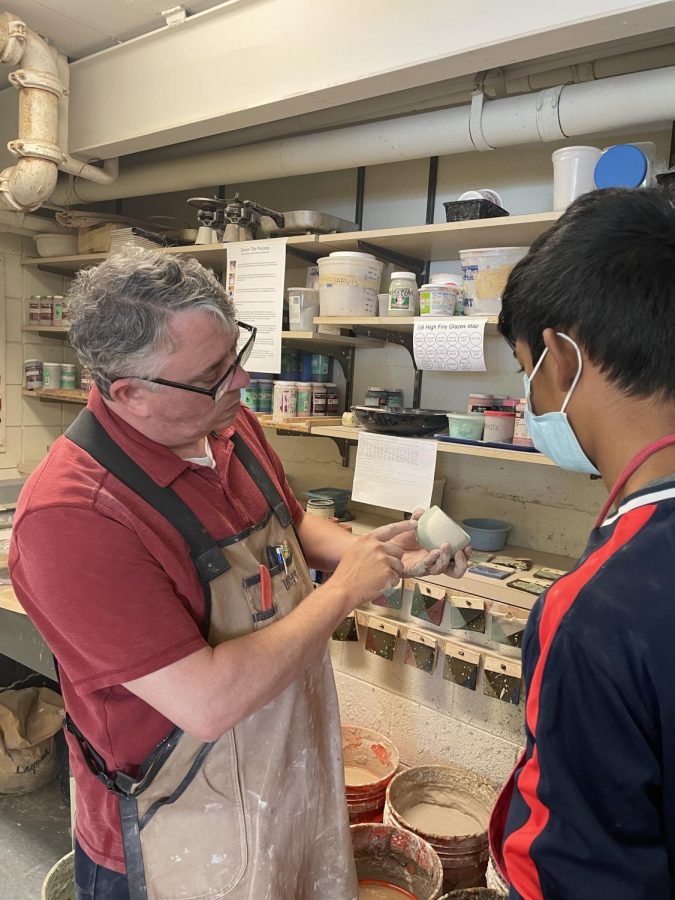 SPIN IT, GLAZE IT Rob Kinnaird helping a student with their ceramics project. “I’m applying to art schools because he has honestly inspired me to pursue a passion I didn’t know I had,” said Stone. “I wouldn’t have fallen in love with art with a different teacher.”