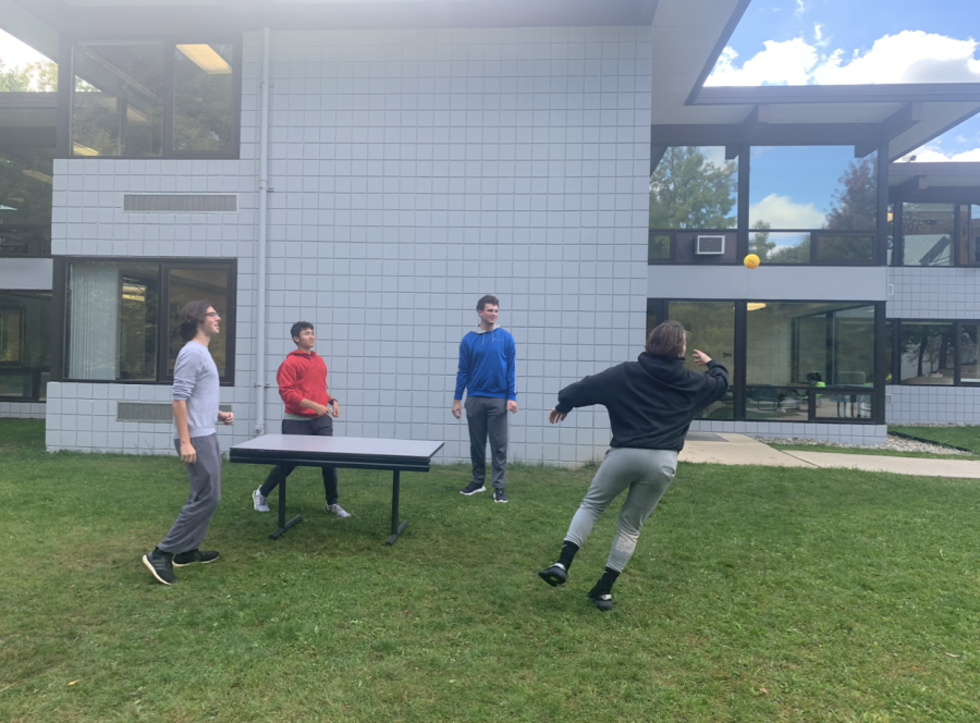 SERVE IT UP (From left to right, Tom Lucas ‘23, Dylan Carvette ‘23, Sam Dorfman ‘23, and Nick Cantrell ‘23.) Cantrell dives for a ball in an intense game of outdoor beach pong. “Beach pong is a great mix of spike ball, volleyball, and ping pong,” said Cantrell. “There isn’t a game to play during my free that’s more fun.” 