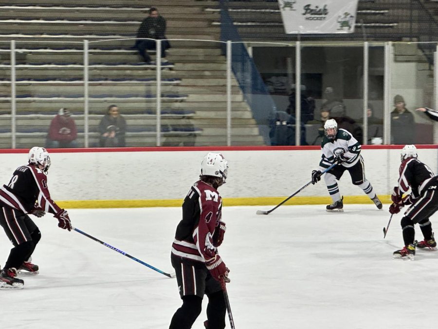 Ryan Kowalchik 23 maintains possession of the puck while attacking the defense.