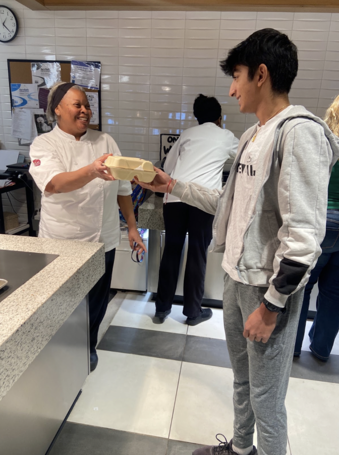 BON APPETIT Francine Mays hands a student the last meal she will give out. “I have been so happy to work here.” 