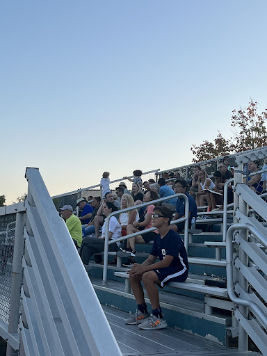 ONE STUDENT IN THE STANDS Parents packed the stands for Greenhills High School soccer with only one student fan: middle schooler Arrio Atienza ‘30, pictured center.  
