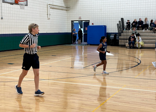 TWEET TWEET Charlie Rich ‘26 referees a middle school girls’ basketball game. 
