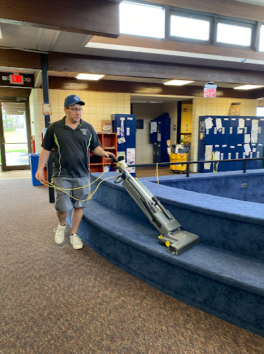 TIDYING UP Facilities staff member Sam Cash works to make sure the sixth-grade forum is ready for students to learn and interact in. “I really love my job here,” said Cash. “I feel lucky to have great benefits that come with my job and enjoy what I’m doing at the same time.”