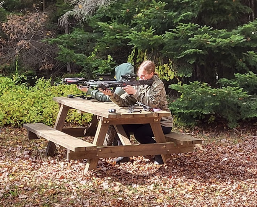 TARGET, AIM, FIRE Flohr practices shooting on targets in the yard with a bow alongside her cousin. Flohr had to undergo hunter safety training before she could start hunting to ensure the right precautions were being taken. “Even experienced hunters can make a miss-hit, where you accidentally wound an animal when you hit it,” said Flohr. “That is why we practice constantly and have very strict rules to make sure no one gets hurt and we aren’t accidentally wounding them.”