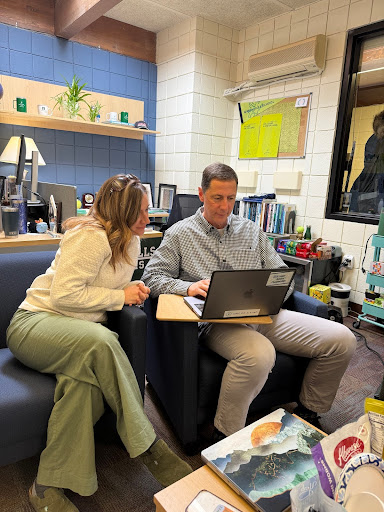 BUSY SEASON Christy Loewen, pictured left, and Eric Gajar, pictured right, read an application for the next year. “A lot of people ask, what does it take to be admitted?” said Gajar. “We are first and foremost a college prep school, so we want people who can handle that, but [who] also are good citizens to have as a part of the community.”